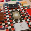 Board game with category cards, a die and playing pieces on a grid board
